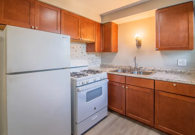 a kitchen with stainless steel appliances granite countertop a refrigerator sink and cabinets
