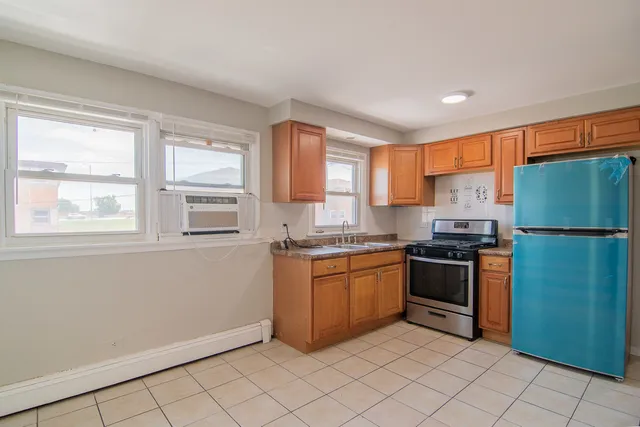 a kitchen with stainless steel appliances granite countertop a refrigerator oven a sink and dishwasher
