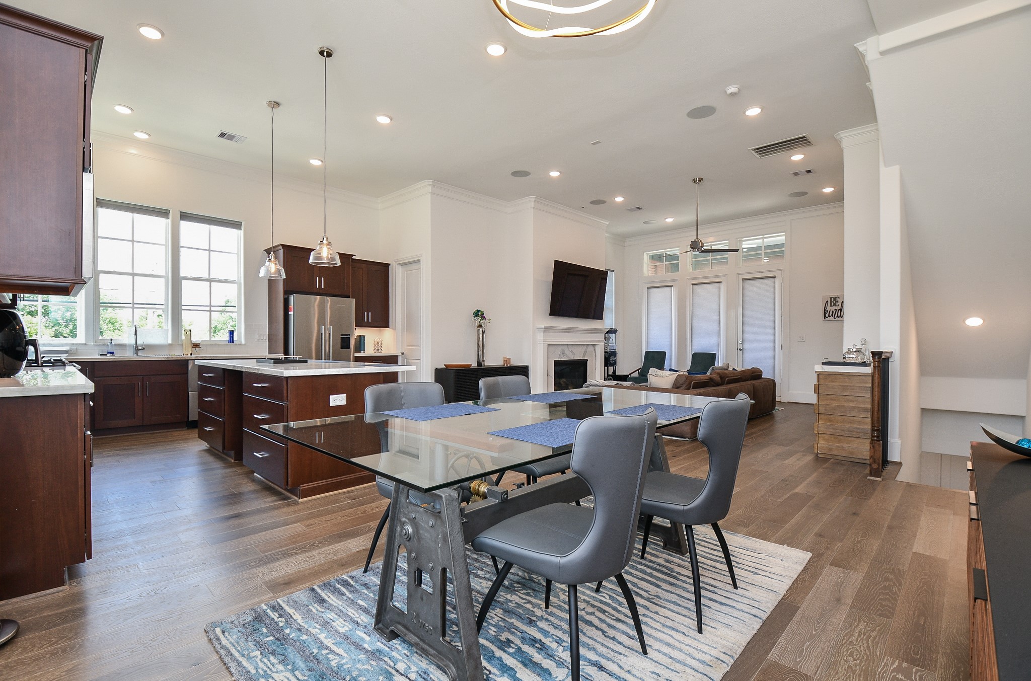 703 Bringhurst Street Houston, TX 77020 - Photo 12 of 27 Bright and airy kitchen with large windows, modern stainless steel
refrigerator, wood flooring, and
decorative wall accents. Perfect for a
contemporary home.