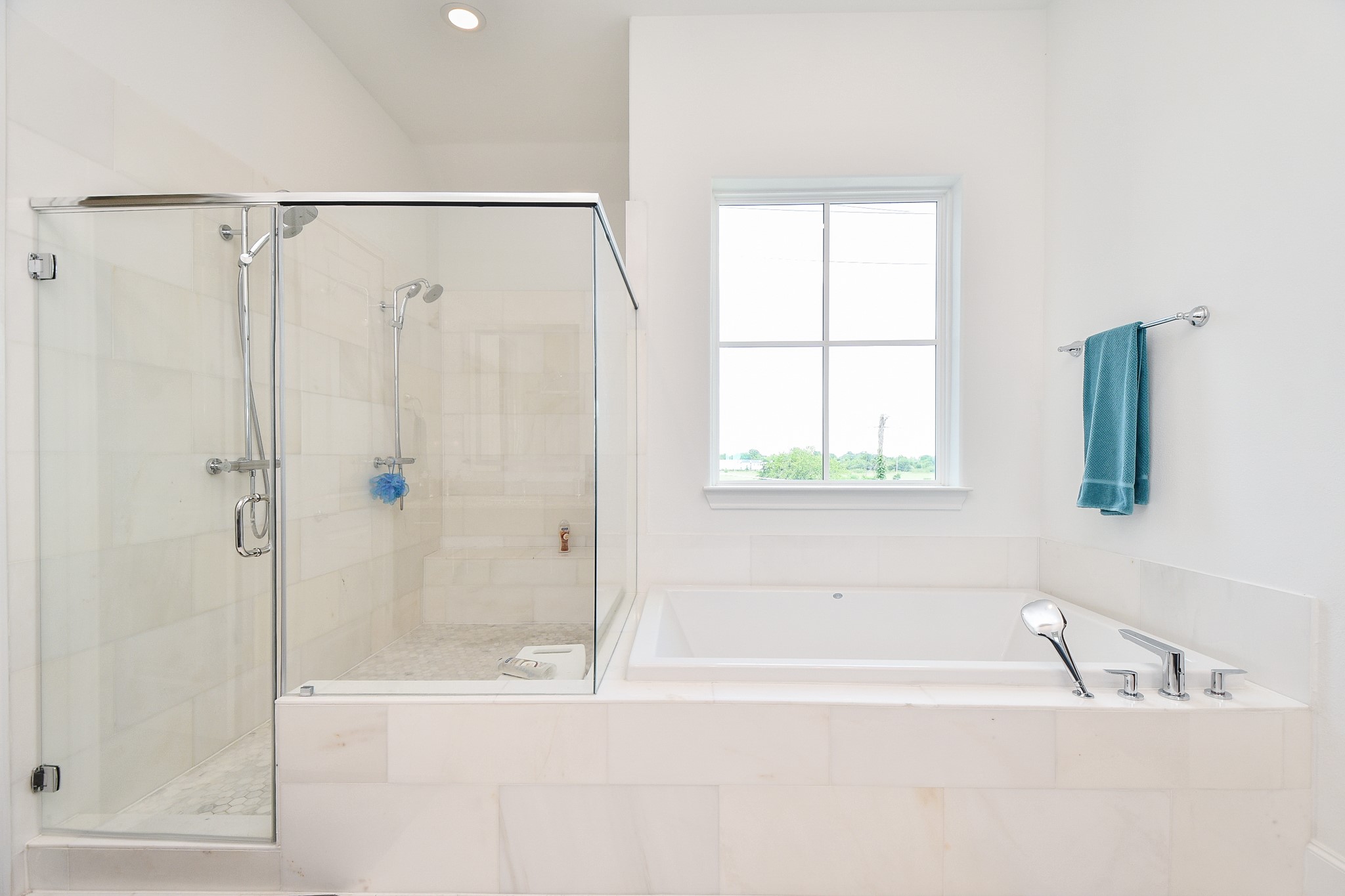 703 Bringhurst Street Houston, TX 77020 - Photo 19 of 27 This modern bathroom features a sleek freestanding tub, a glass-
enclosed shower with stylish tile, dual sinks with ample counter space, and contemporary fixtures, offering a clean and elegant design.