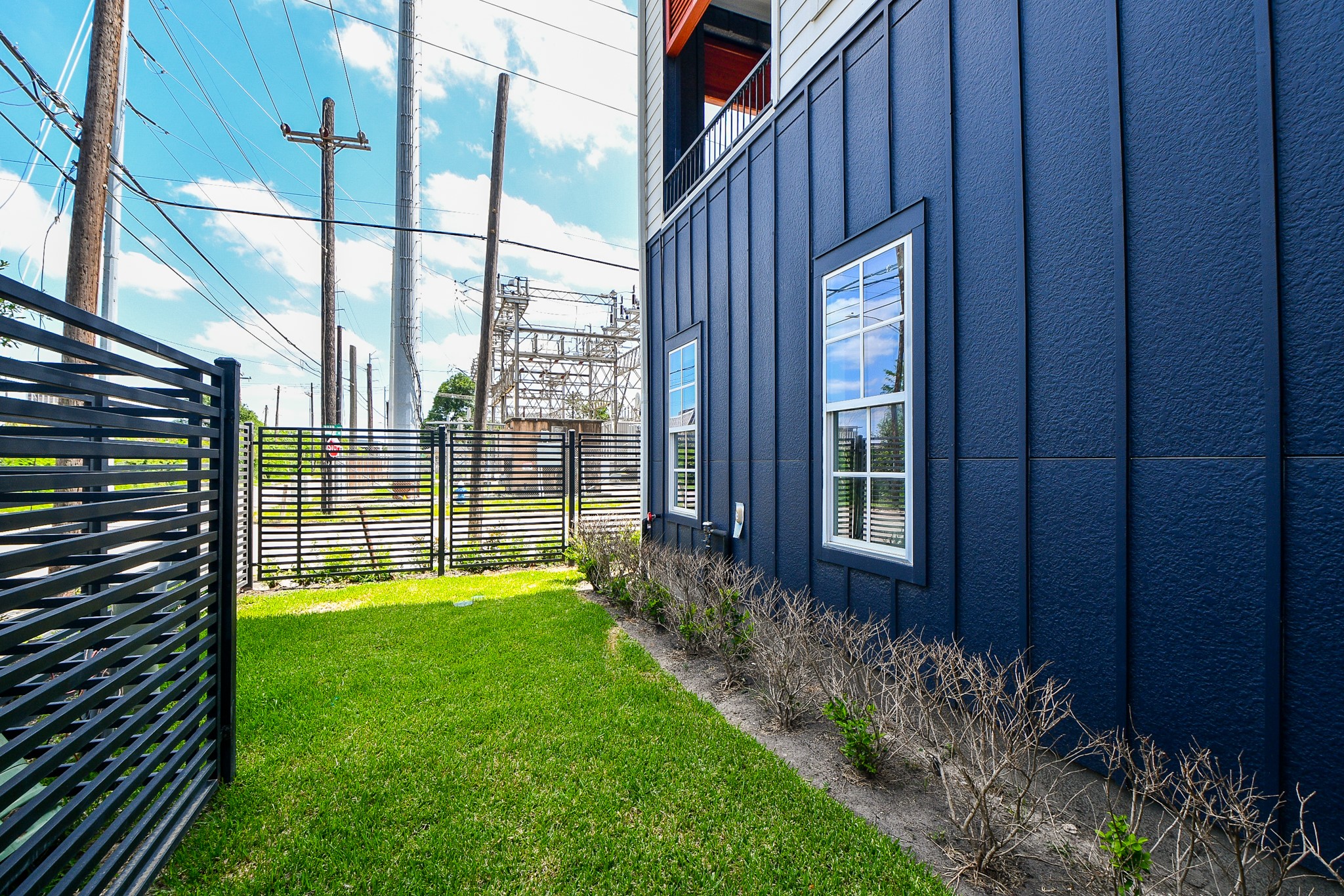 703 Bringhurst Street Houston, TX 77020 - Photo 25 of 27 Modern townhome with a gated entrance, providing privacy and
security. The exterior features contemporary design elements with
large windows and a clean, neutral
color palette.