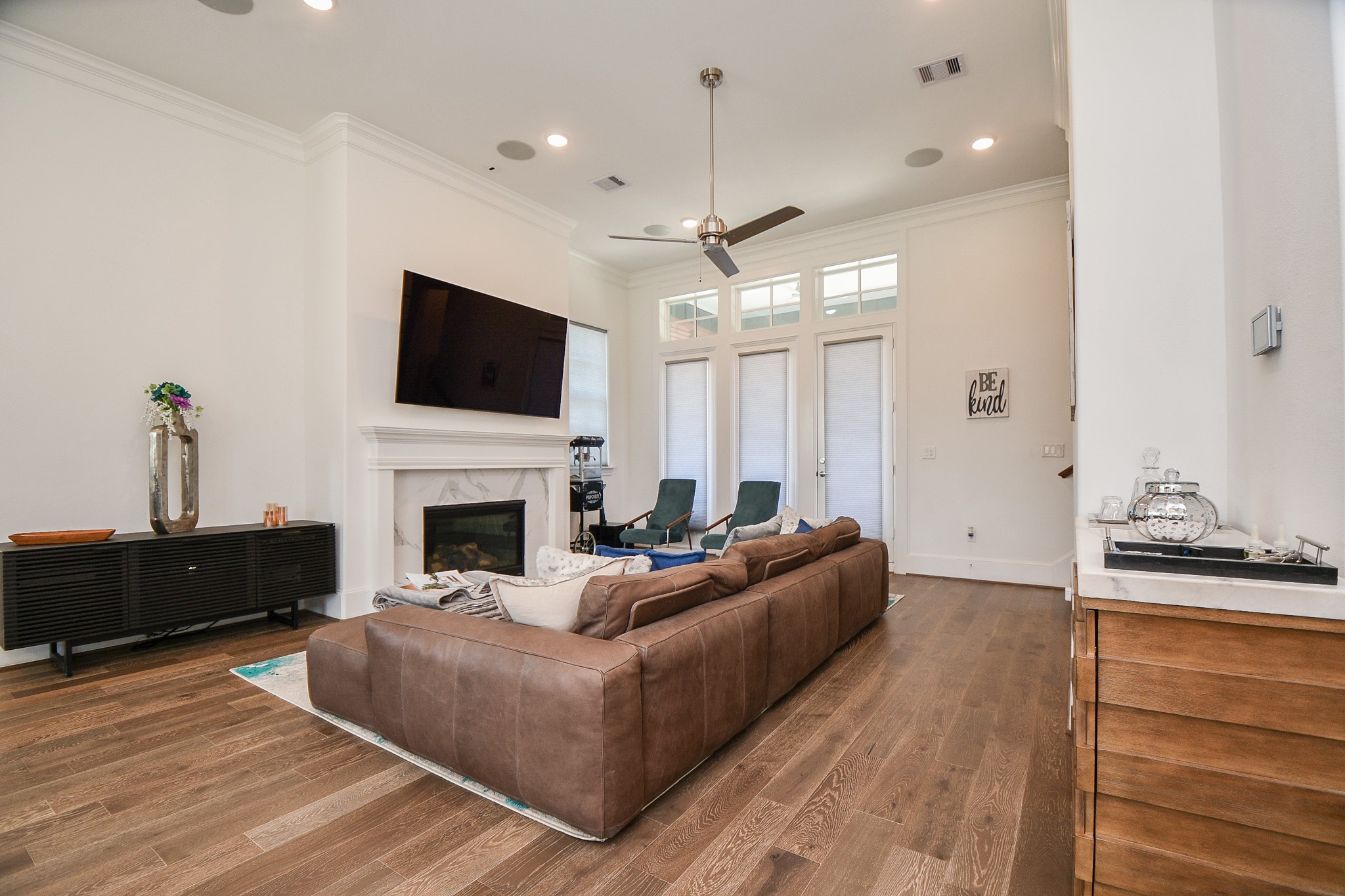 703 Bringhurst Street Houston, TX 77020 - Photo 5 of 27 This modern living room features a spacious layout ready for your sleek or sofa pieces. Large flat-screen TV's included. Elegant wood flooring. Natural
light floods in through multiple windows leading to an outdoor space. A stylish wood staircases