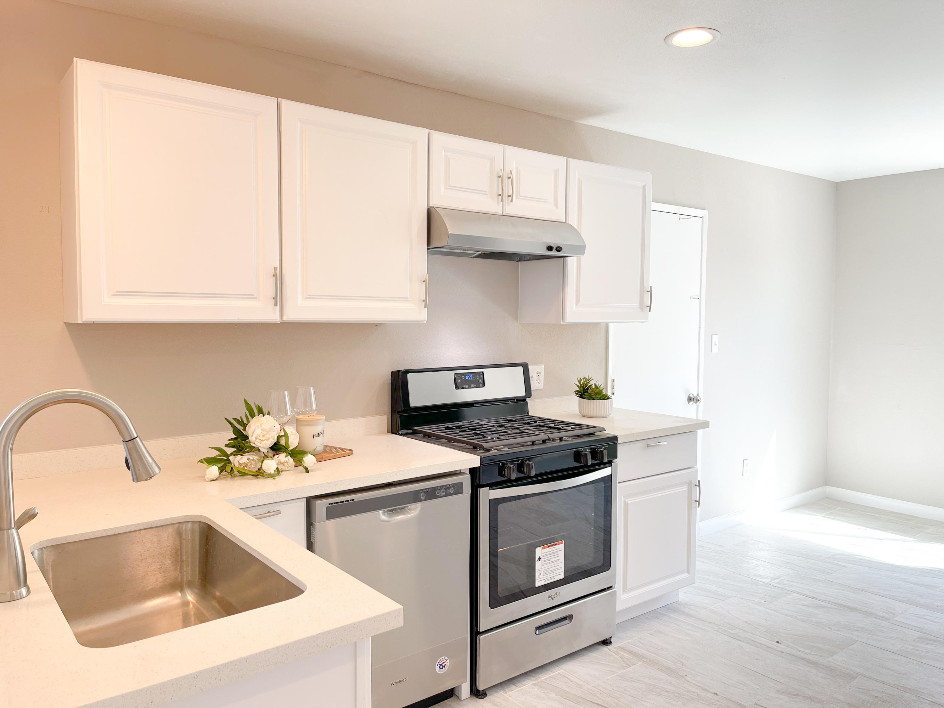 429 Peg Street Ridgecrest, CA 93555 - Photo 9 of 20 a kitchen with stainless steel appliances granite countertop a sink stove and white cabinets