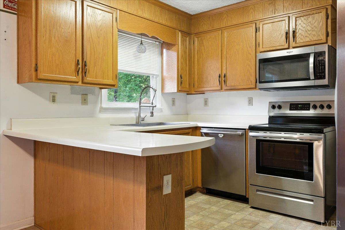 2926 Forbes Mill Road Bedford, VA 24523 - Photo 11 of 36 a kitchen with stainless steel appliances granite countertop a sink a stove a microwave and cabinets