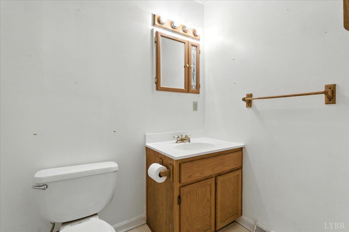 2926 Forbes Mill Road Bedford, VA 24523 - Photo 16 of 36 a bathroom with a sink toilet and mirror