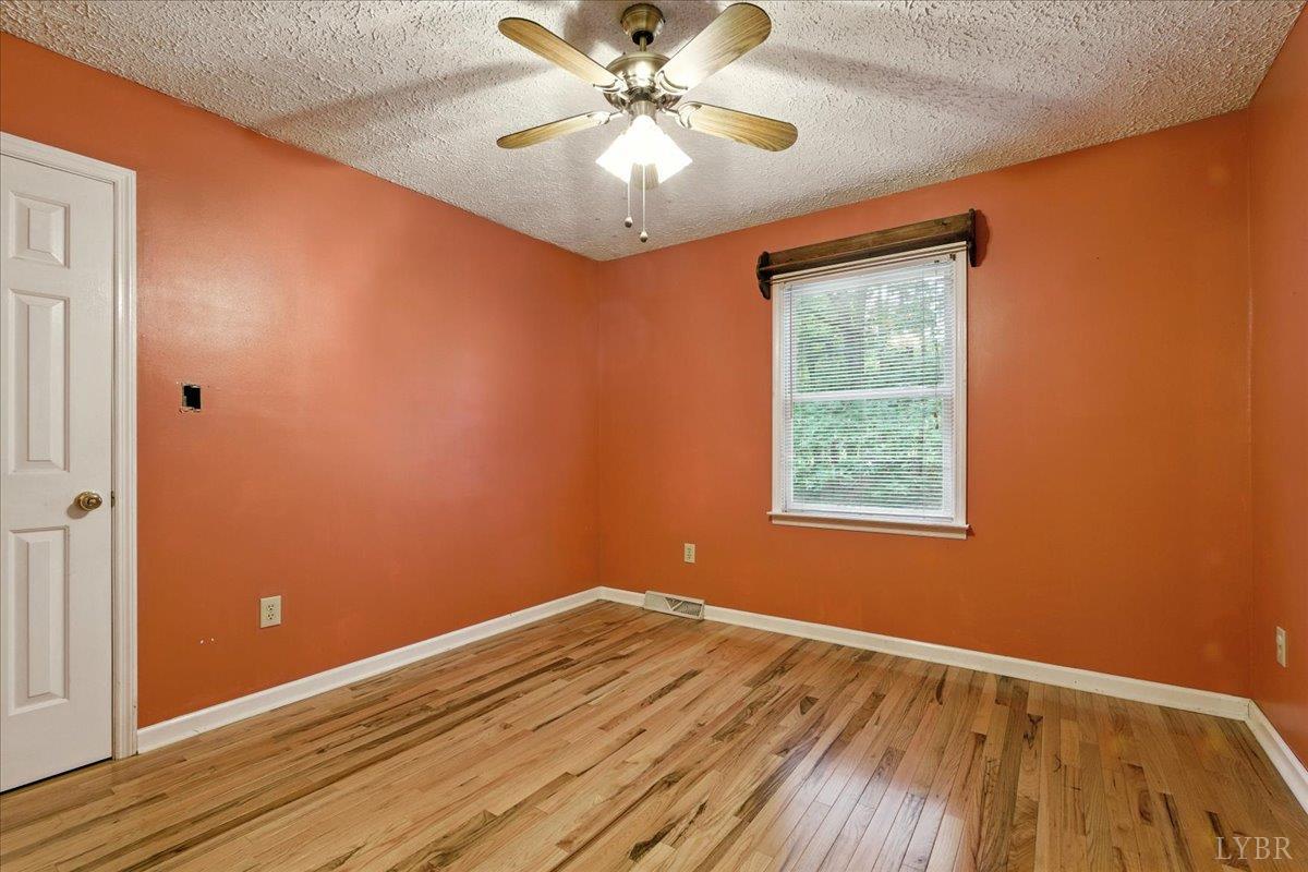 2926 Forbes Mill Road Bedford, VA 24523 - Photo 17 of 36 an empty room with a window and a ceiling fan