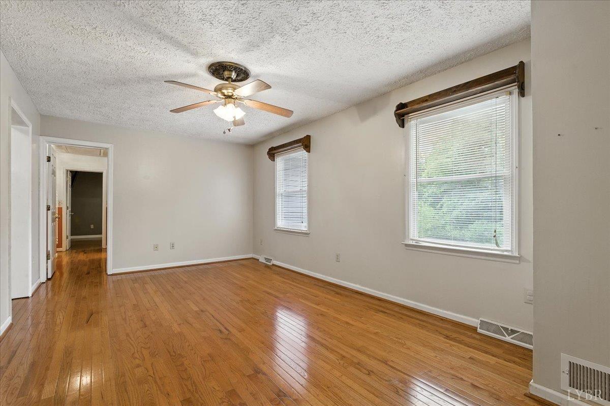 2926 Forbes Mill Road Bedford, VA 24523 - Photo 8 of 36 a view of an empty room with wooden floor and a window