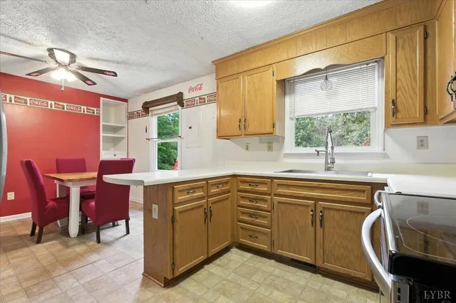 a kitchen with a table chairs sink and cabinets