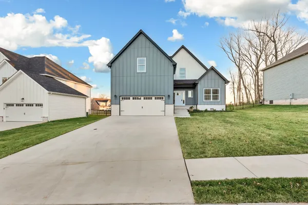 a view of an house with backyard space and tree