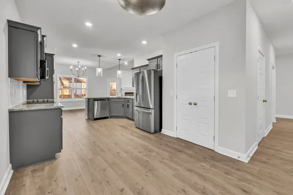 a open kitchen with stainless steel appliances granite countertop a refrigerator and a sink