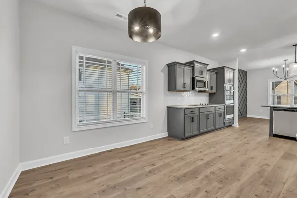 a kitchen with stainless steel appliances a refrigerator sink and microwave