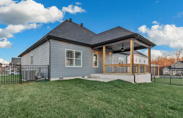 a view of a house with a yard and sitting area