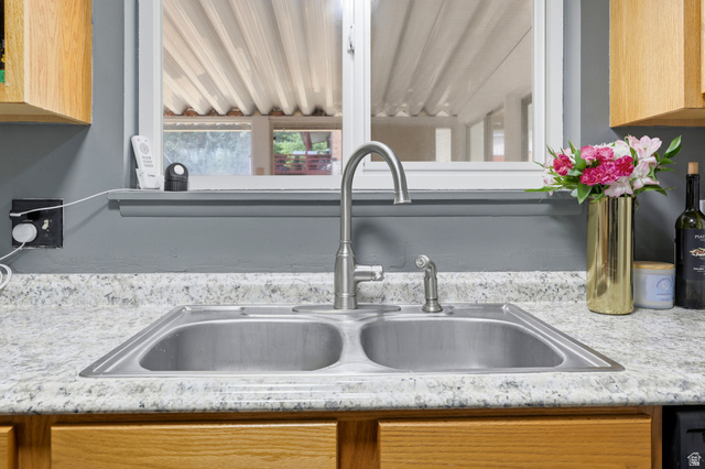 1486 3rd Street Ogden, UT 84404 - Photo 8 of 26 Double basin stainless steel sink with a high-arc faucet, set within a speckled countertop