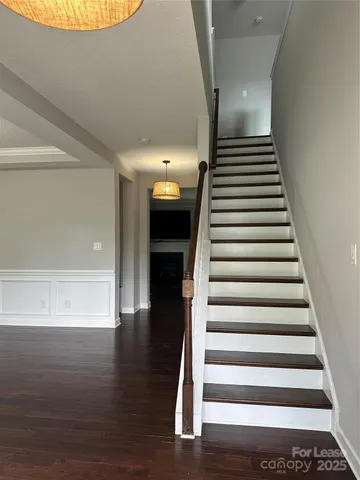a view of entryway and hall with wooden floor
