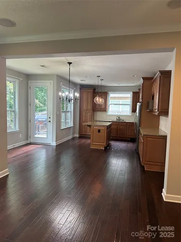a living room with furniture and hard wood flooring