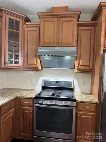 a stove top oven sitting inside of a kitchen