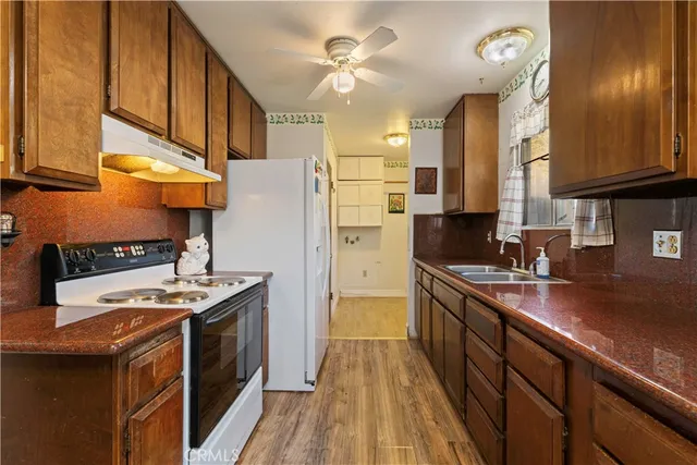 a kitchen with stainless steel appliances a sink stove and refrigerator