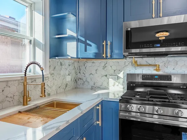 a stove top oven sitting inside of a kitchen