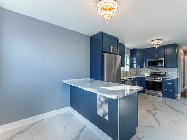 a kitchen with a sink a stove a refrigerator and a microwave