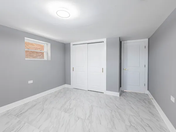 an empty room with wooden floor and closet