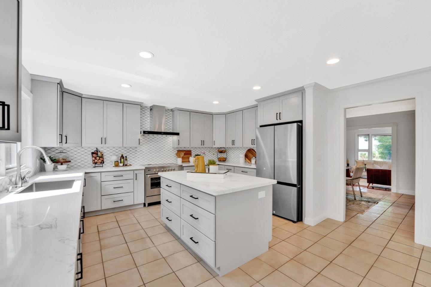46950 Zapotec Drive Fremont, CA 94539 - Photo 12 of 40 a kitchen that has a lot of white cabinets and stainless steel appliances