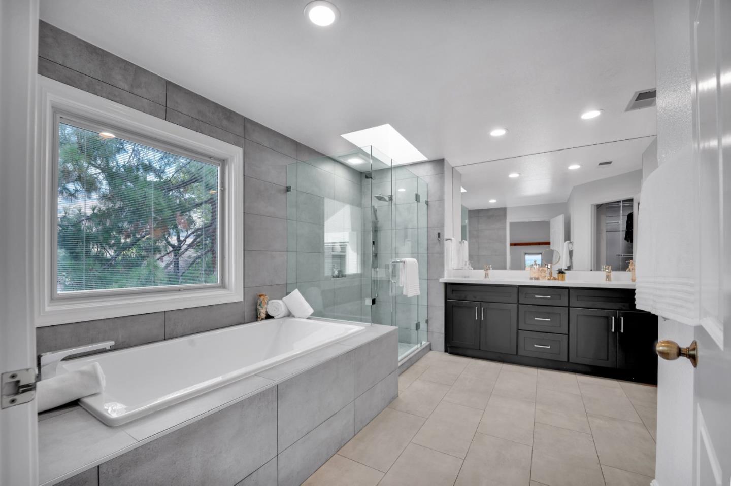 46950 Zapotec Drive Fremont, CA 94539 - Photo 26 of 40 a spacious bathroom with a granite countertop tub sink and mirror