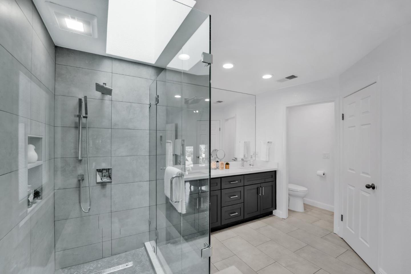 46950 Zapotec Drive Fremont, CA 94539 - Photo 28 of 40 a bathroom with a double vanity sink toilet and shower