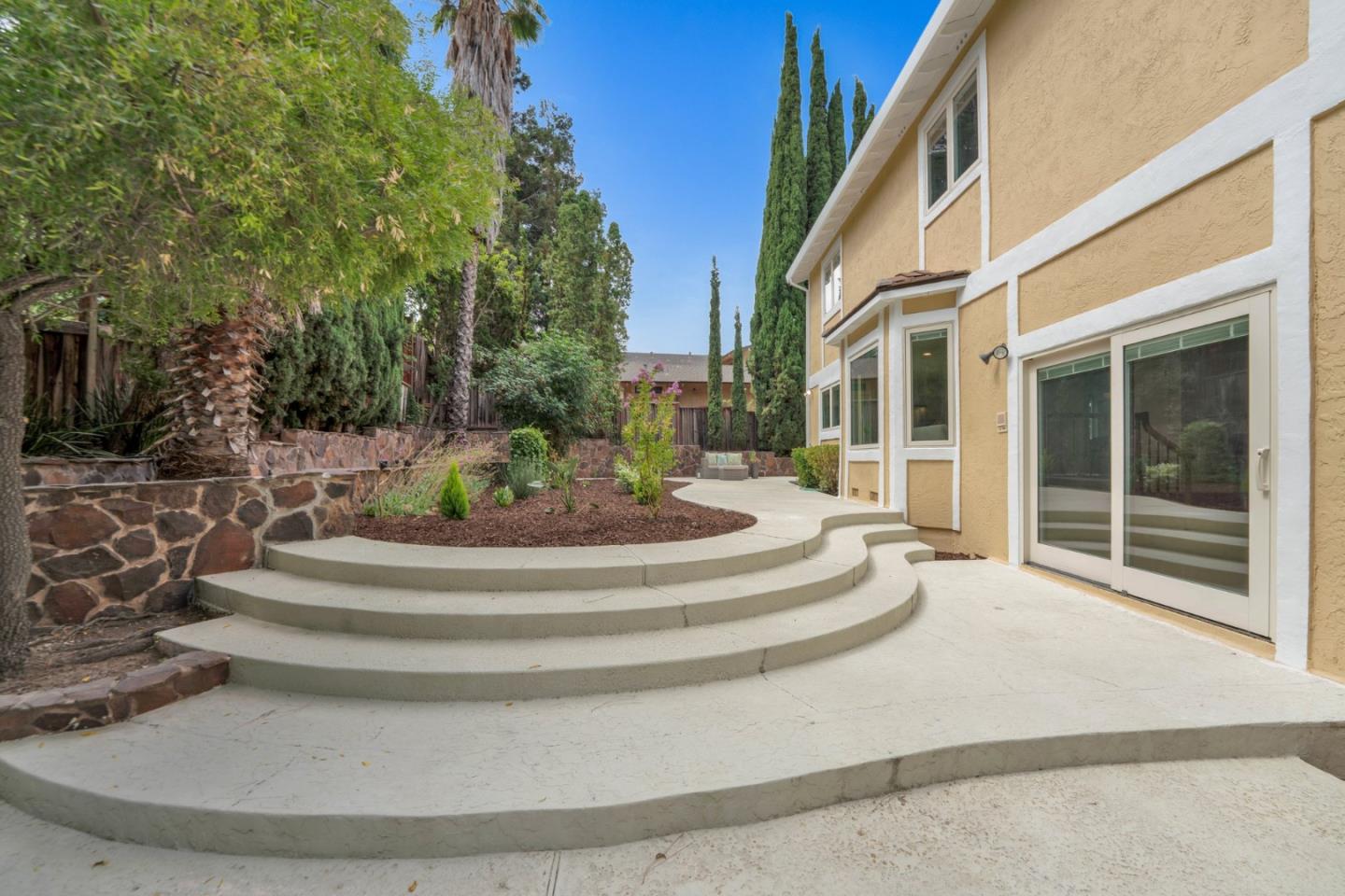 46950 Zapotec Drive Fremont, CA 94539 - Photo 35 of 40 a view of a white house with a fountain and a fountain with plants