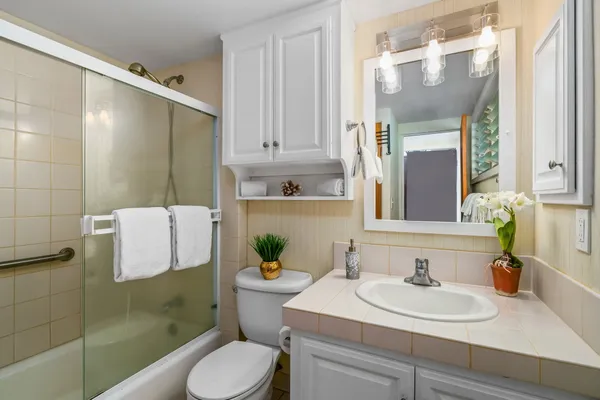 a bathroom with a sink toilet and shower