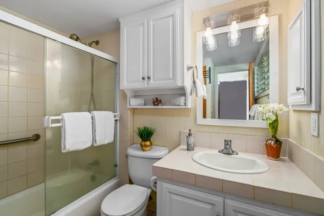 a bathroom with a sink toilet and shower