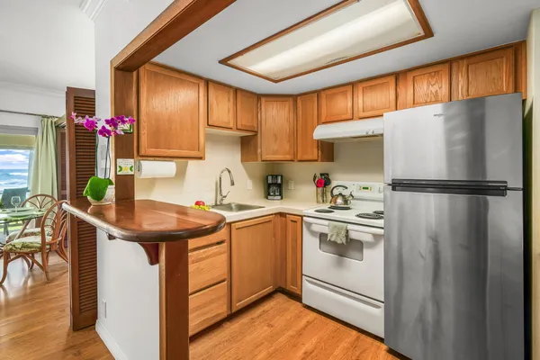 a kitchen with stainless steel appliances granite countertop a refrigerator sink and cabinets