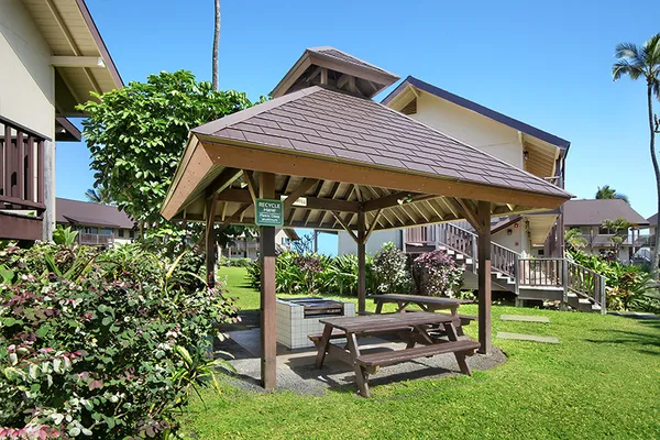 a view of patio with a table and chairs under an umbrella