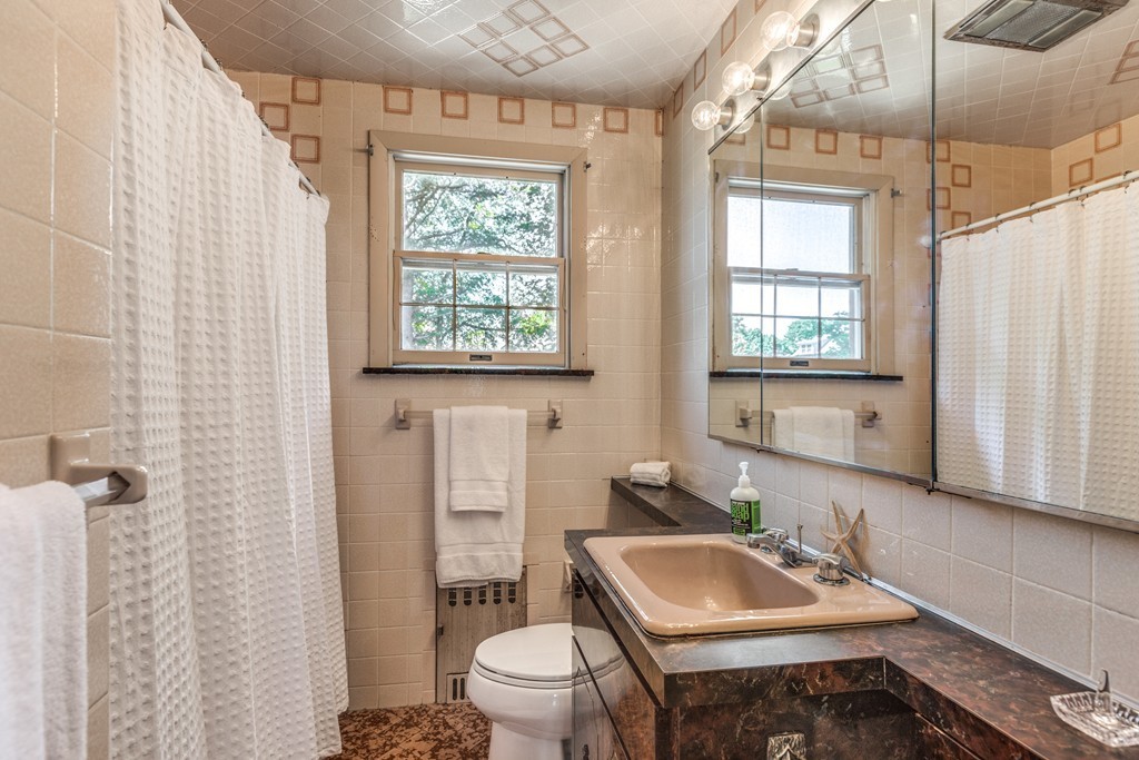 16 Marion Road Marblehead, MA 01945 - Photo 25 of 30 a bathroom with a sink toilet and shower