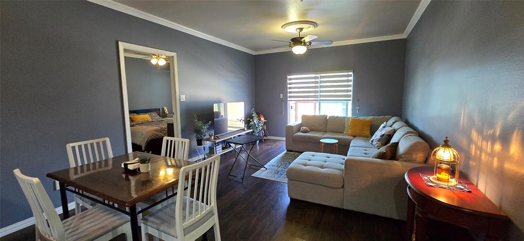 1100 West Trinity Mills Road, Unit 2045 Carrollton, TX 75006 - Photo 1 of 20 Dining area featuring dark wood-type flooring, crown molding, and ceiling fan