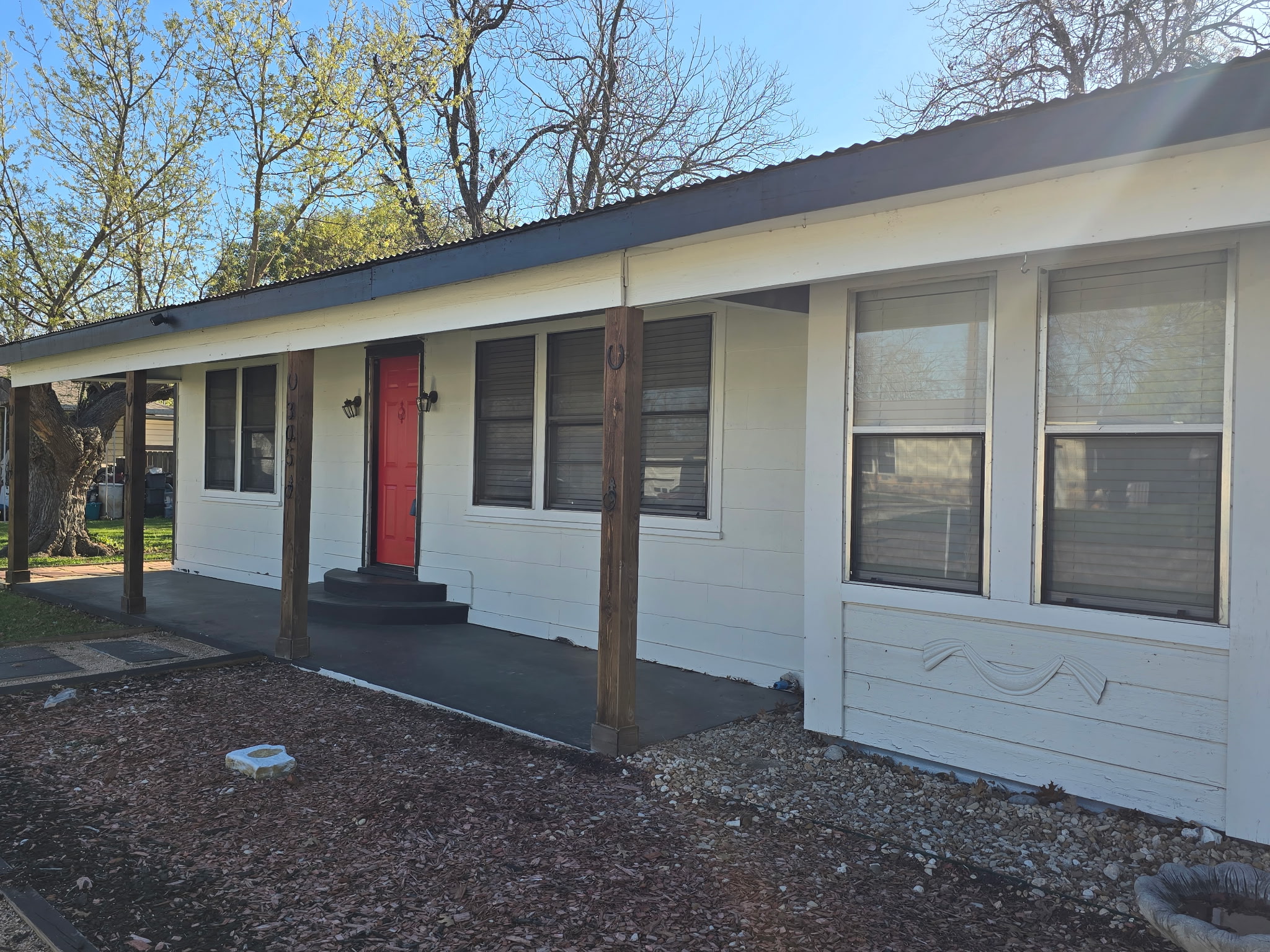 305 North 5th Street Thorndale, TX 76577 - Photo 2 of 20 a view of yellow house with a large window and yard