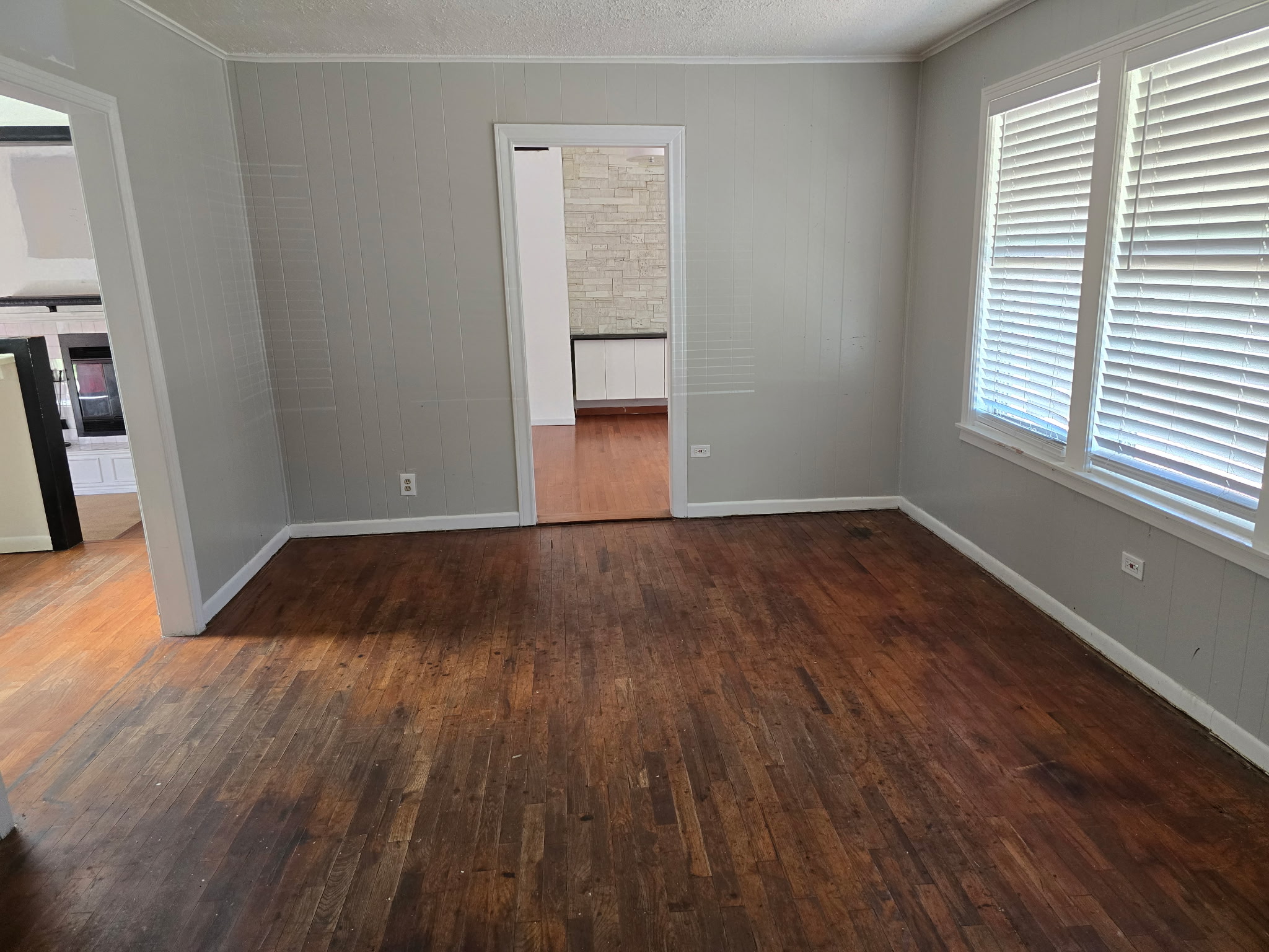 305 North 5th Street Thorndale, TX 76577 - Photo 5 of 20 an empty room with wooden floor and windows