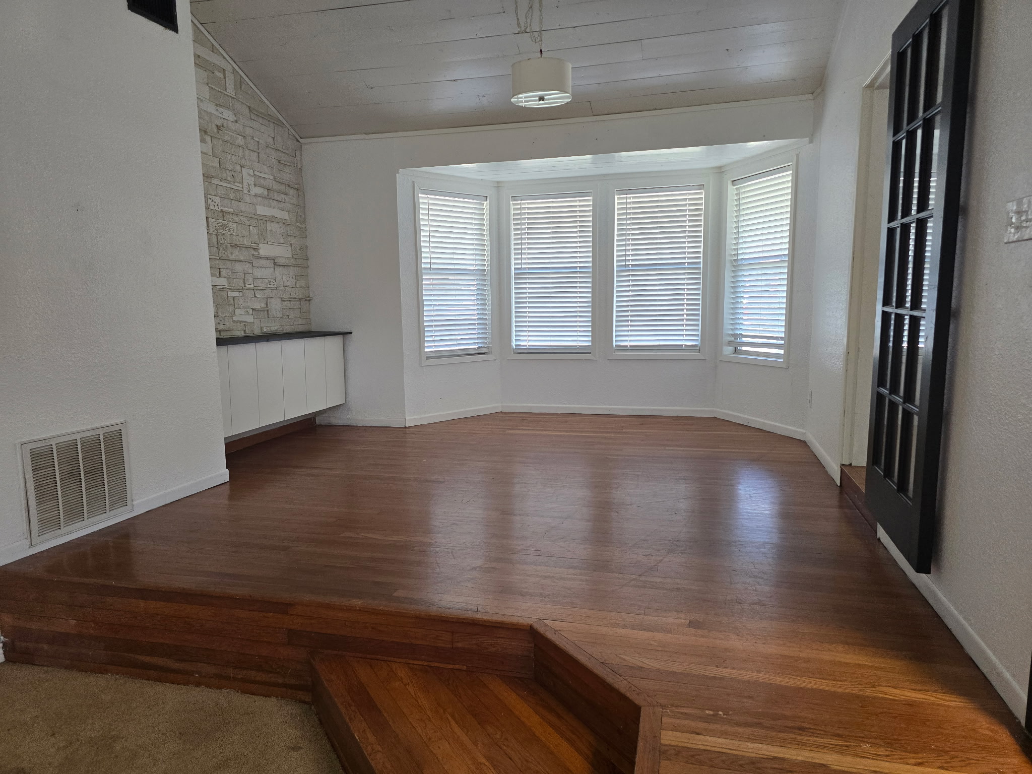 305 North 5th Street Thorndale, TX 76577 - Photo 6 of 20 a view of wooden floor and windows in a room