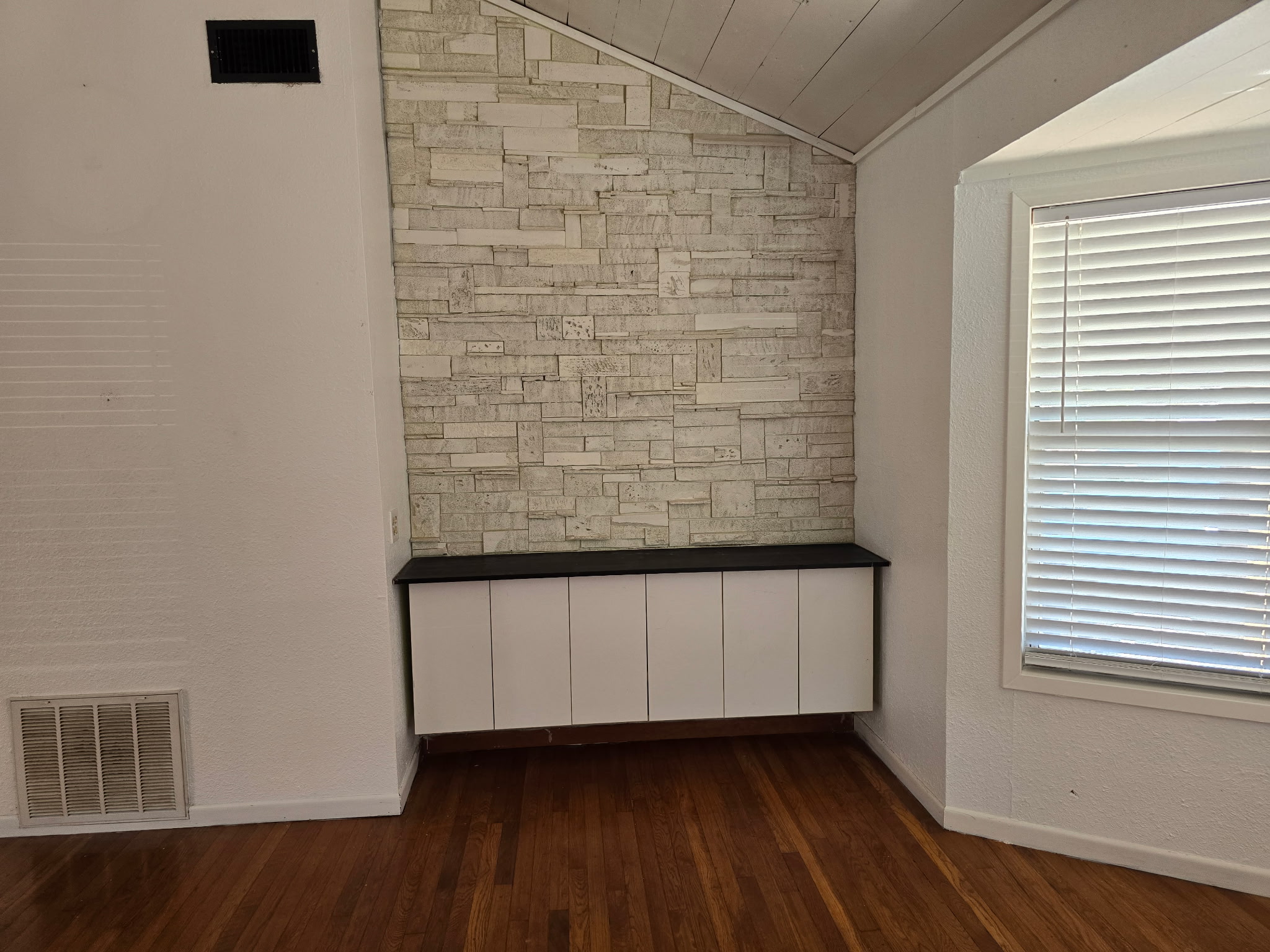 305 North 5th Street Thorndale, TX 76577 - Photo 8 of 20 a view of an empty room with wooden floor and a window