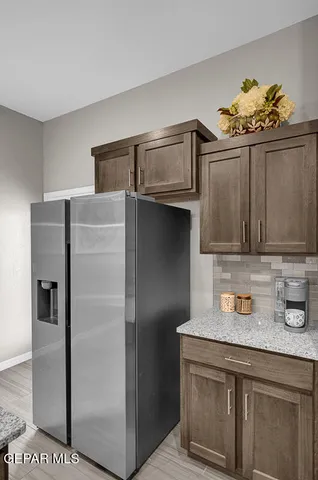a kitchen with stainless steel appliances granite countertop a refrigerator and a sink