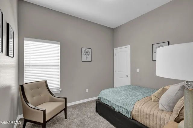 a bedroom with a bed and a chair