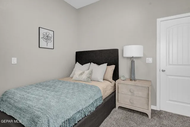 a bed room with a bed and a night stand