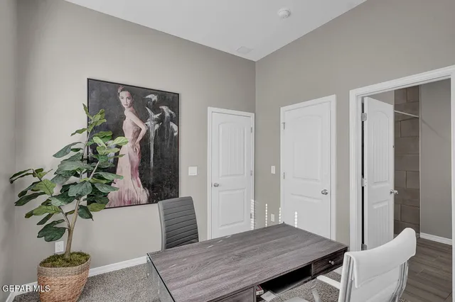 a living room with furniture potted plant and wooden floor