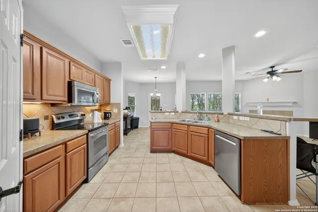 a large kitchen with stainless steel appliances lots of counter top space