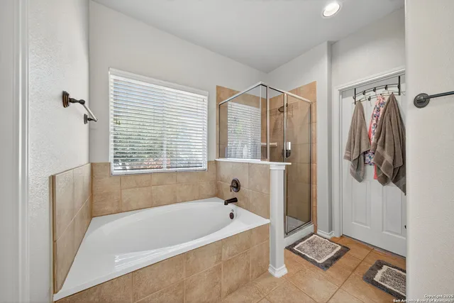 a bathroom with a tub a toilet and a shower