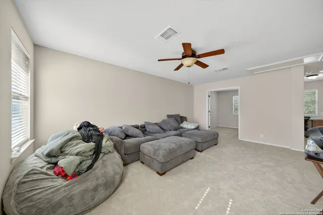 a living room with furniture and white walls