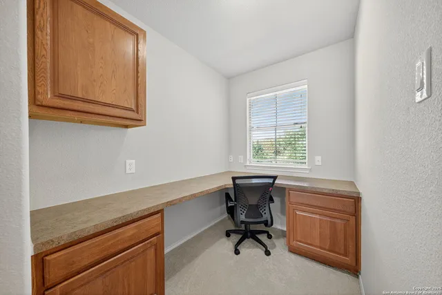 a room that has a chair and a window in it