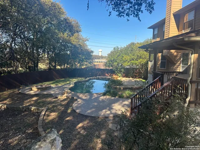 a view of a street with houses in the background