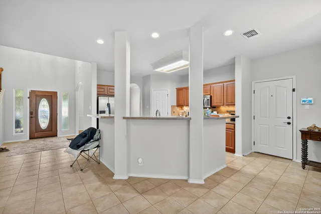 a view of kitchen with furniture and a refrigerator