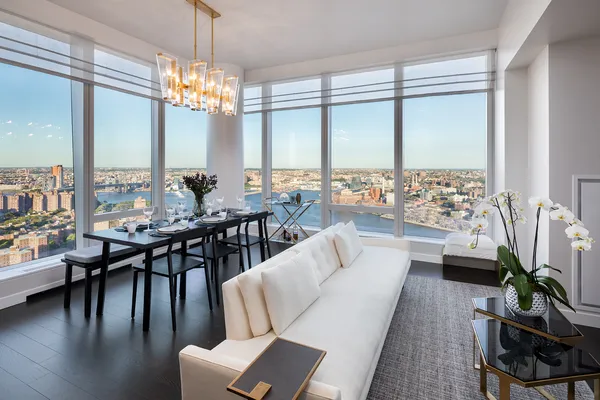 a living room with furniture and a chandelier