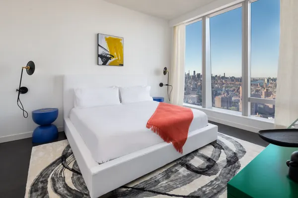 a bedroom with a bed and glass window